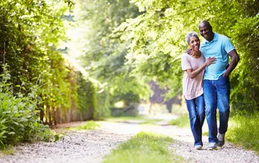 Older African American couple walking outside