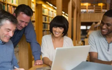 Four educators meeting at a library