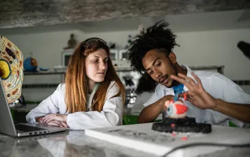 college biology students examining eye model