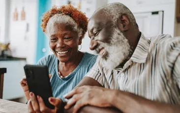 Older couple looking at a phone together