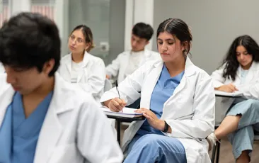 medical student taking notes in class