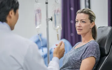 woman with iv talking to doctor