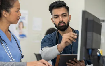 medical workers looking at a computer together