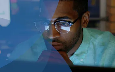 Man looking serious at a computer