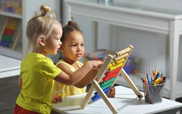 Preschoolers playing with a toy together