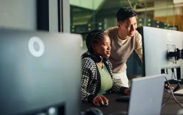 coworkers looking at computer monitor together