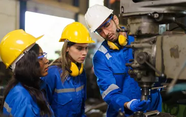 Factory worker with apprentices