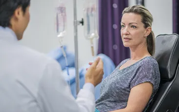 Woman with IV talking to doctor