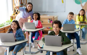 Middle school children on computers in classroom