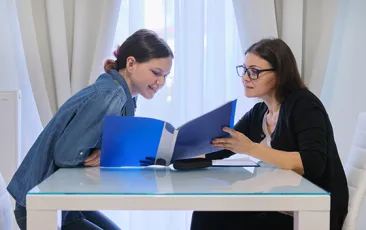 Teacher and student looking at folder
