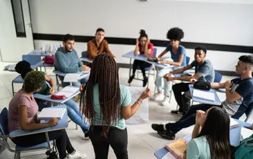 Teacher with circle of older students