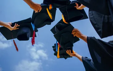 Graduation caps in the air
