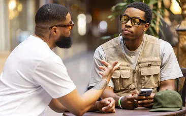 African American men talking at a cafe