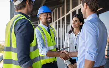 Factory colleagues shaking hands