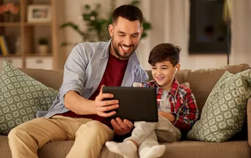 Father and son looking at iPad together