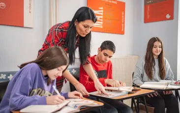 Teacher helping student in class.