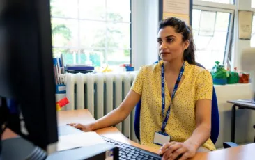 Teacher looking at computer.