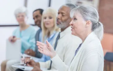Woman answering question in group.