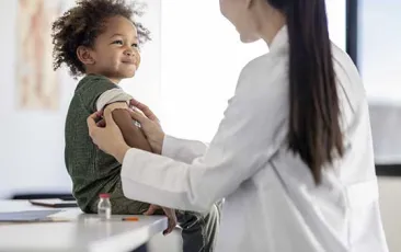 Little boy smiling after getting a shot