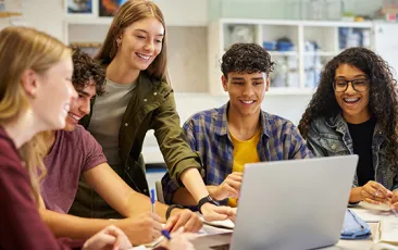 High school students working at a laptop