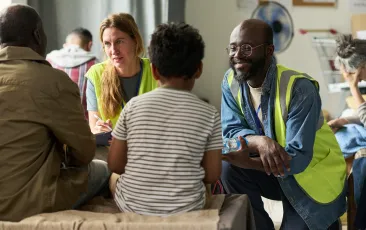 Volunteers Assisting Family during Community Relief Support Meeting