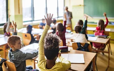 Girl raising her hand in classroom