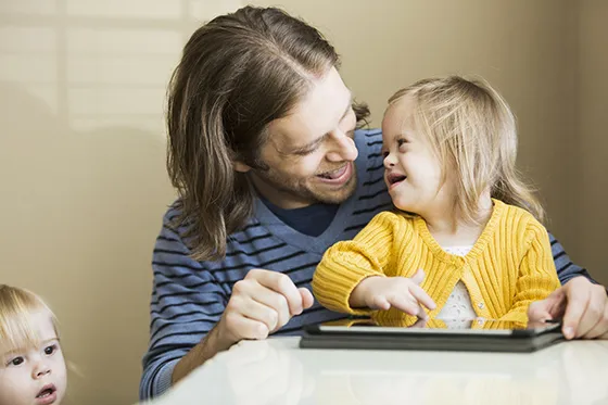 Man holding daughter with Downs syndrome