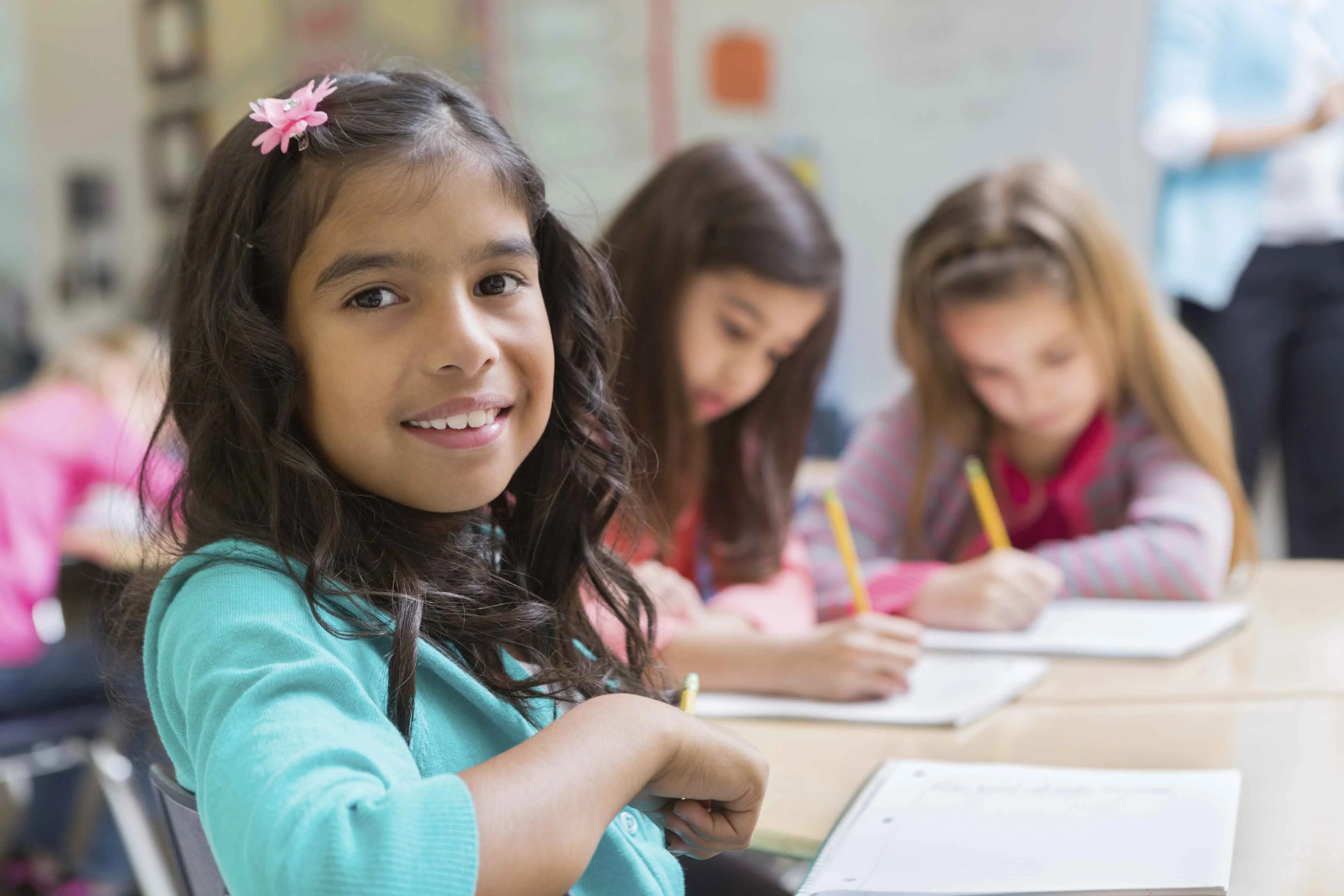 Female student working with friends in classroom