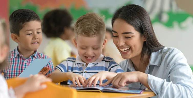 Teacher with smiling young students