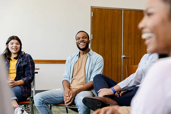 Smiling young people in a therapy group