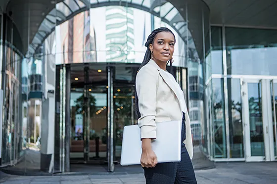 Young business woman outside office building
