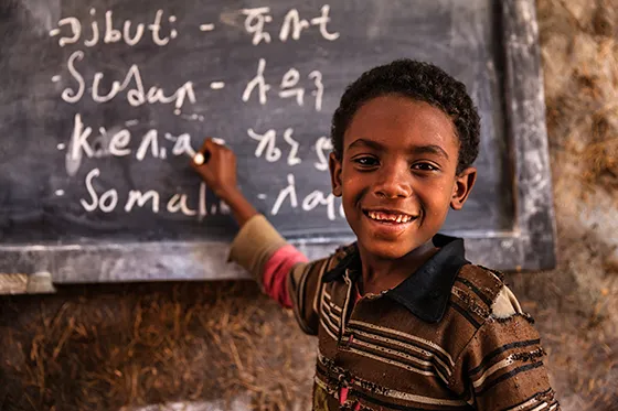 African young boy is learning Amharic language