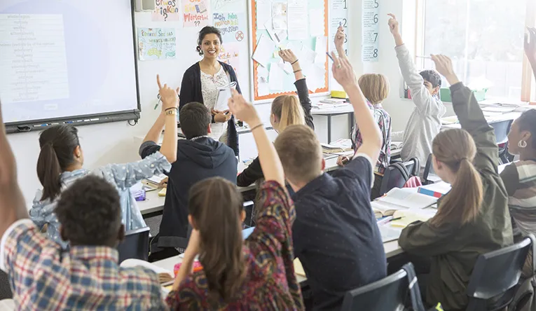 Teacher in front of a high school classroom