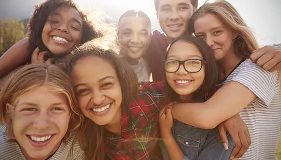 Group of happy teens outside