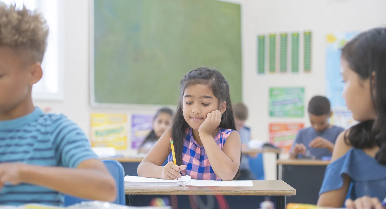 Young girl working in classroom