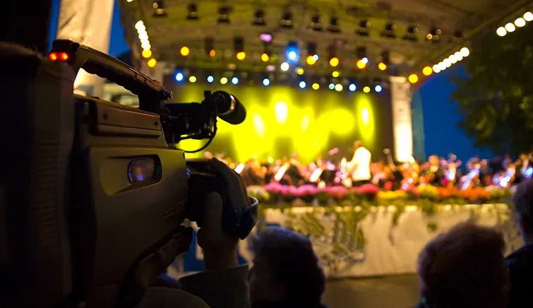 Videographer filming arts performance