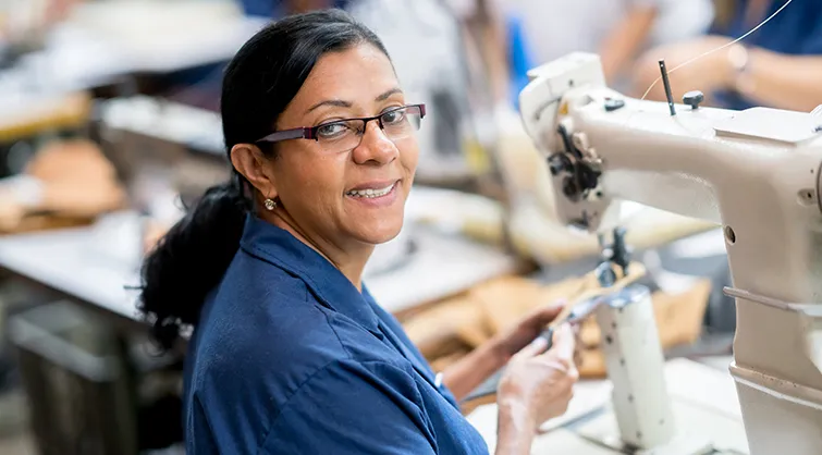 Latin American factory worker with sewing machine