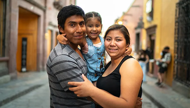 Family smiling on a street in Mexico