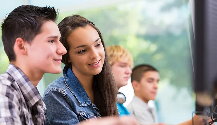 High school student working together at desktop