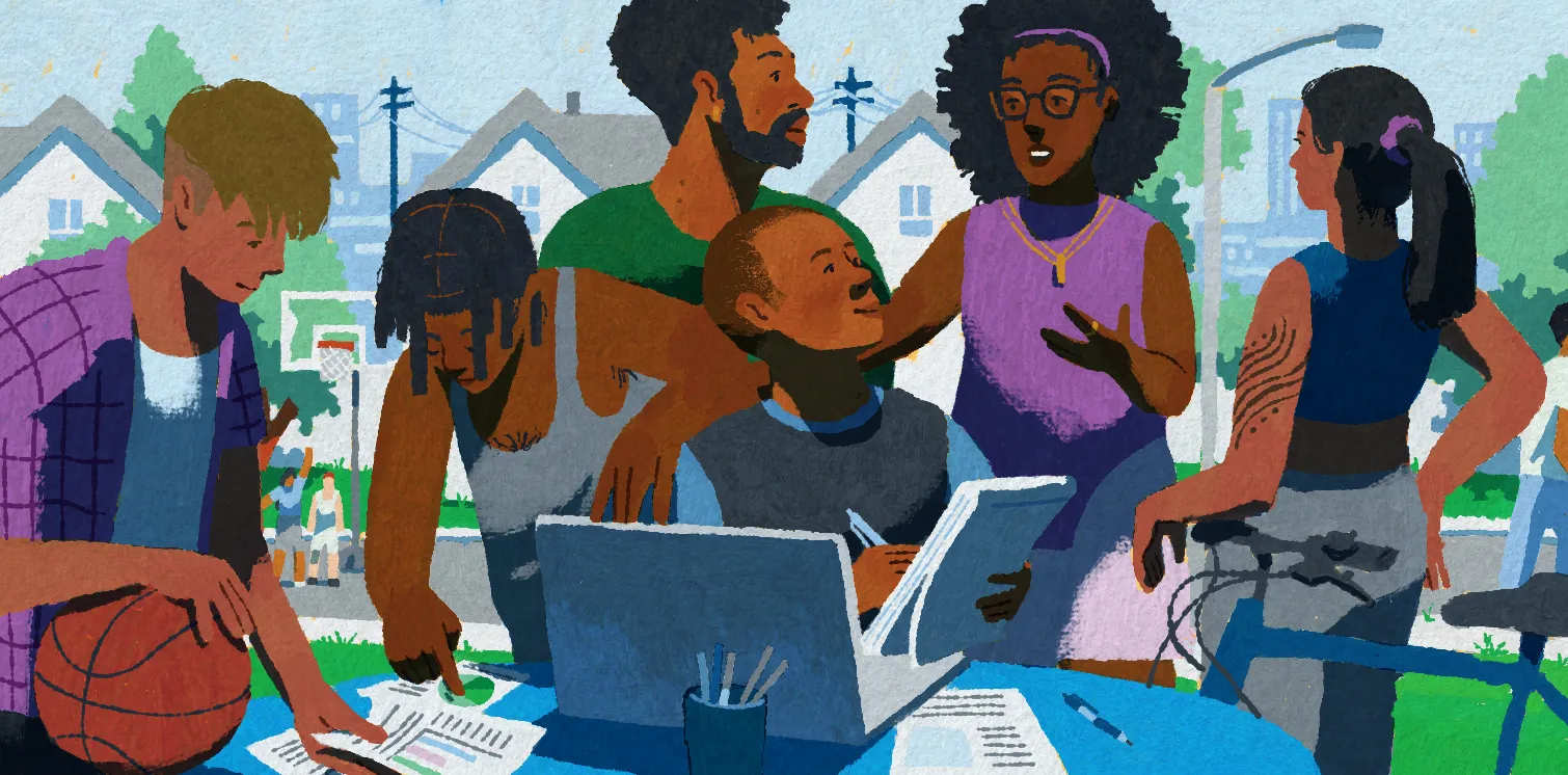 A young researcher from Milwaukee sits at a community table by a neighborhood sidewalk. The young researcher is surrounded by 5 young people from the community. The young researcher is talking to them about their experiences and writing it down on a notepad he's holding. In the distance, youth from the neighborhood are playing basketball.