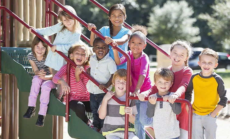 Group of diverse elementary students on playground