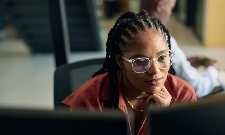 Thoughtful programmer working at her computer