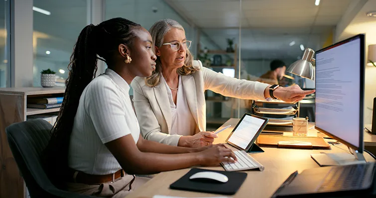 Older and younger colleagues working with data