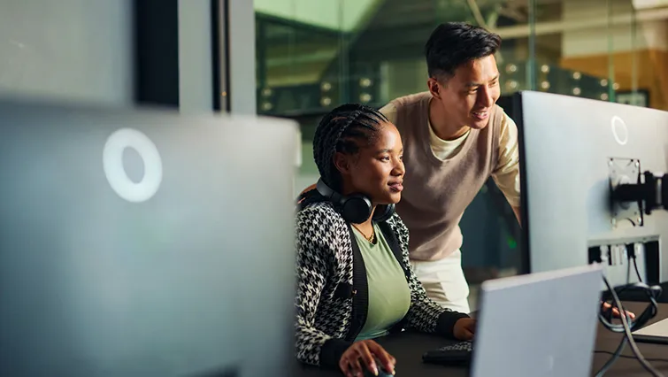 Coworkers looking at computer together