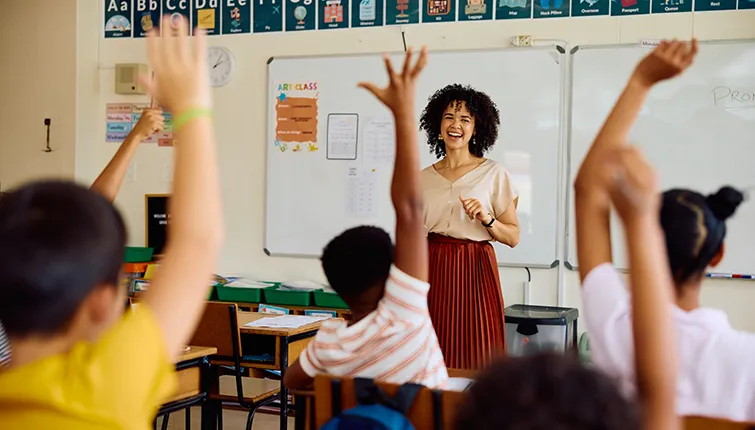 Smiling teacher in front of classroom