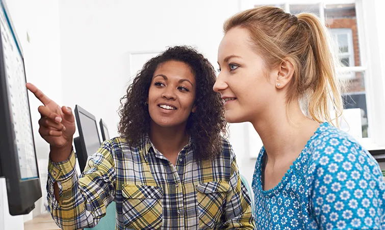 Supervisor and trainee at computer