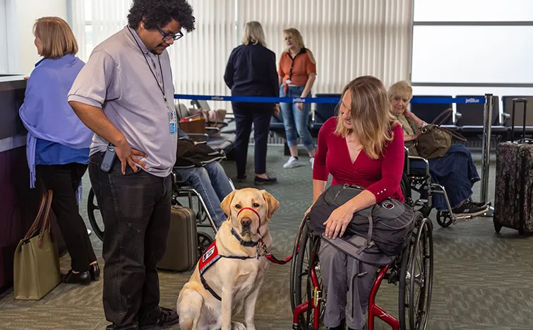 Woman with her guide dog at LAX airport