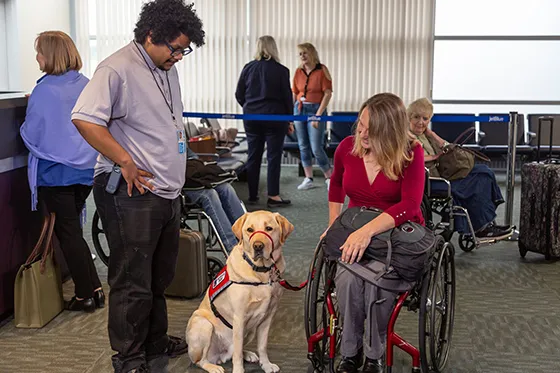Woman with guide dog at airport