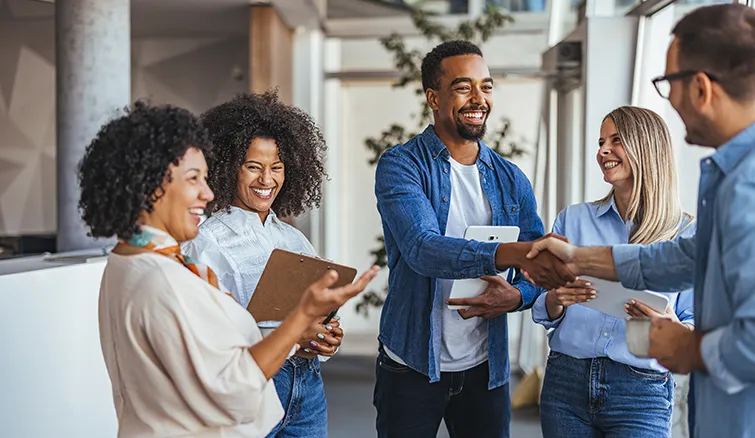 Diverse group of coworkers greeting each other