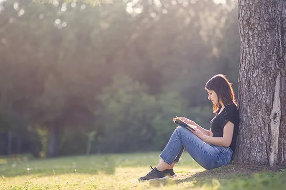 Girl reading under a tree